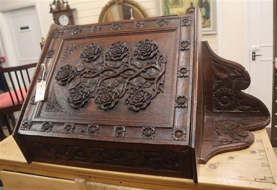 A late Victorian oak hanging corner cabinet carved with Tudor Roses W.56cm